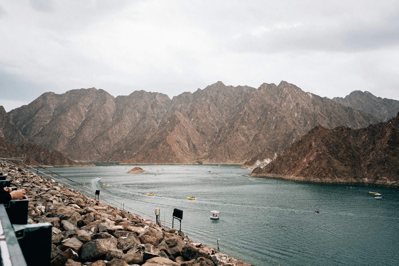 Kayaks on Hatta Dam beneath the mountains